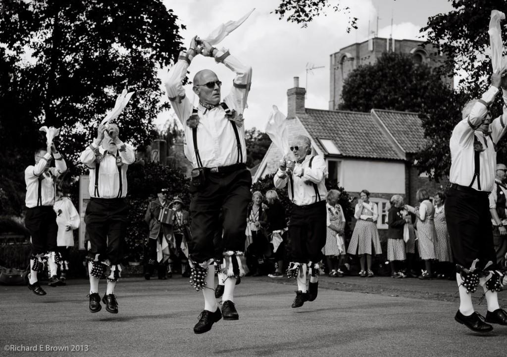 Morris Dancers leaping into the air.