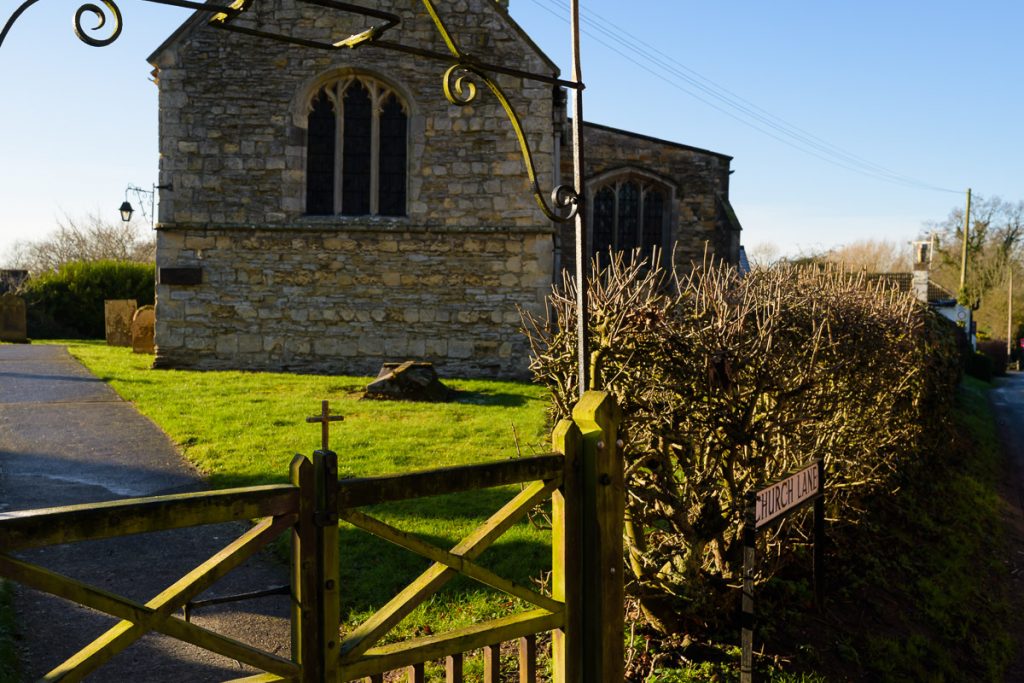 Old village Norman church in bright sunlight.