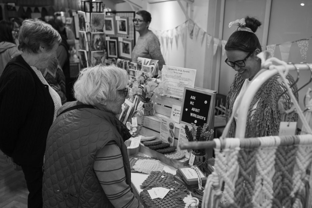Craft stall with a local villager chatting to the stall holder.