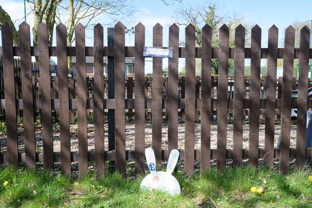 By the model railway that runs around the playing field.