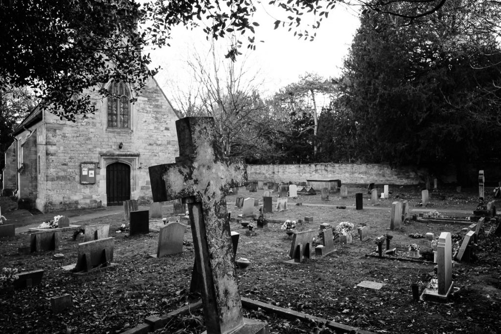 Another view of St Helens church. Again this is a black and white photography with a large stone cross in the foreground.