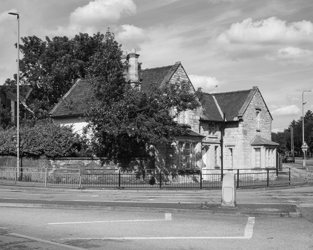 Old house on the corner of a modern roundabout junction in the City of Lincoln