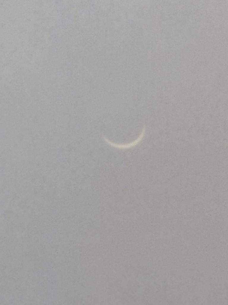 Piece of white paper, with a project from a pinhole showing the eclipse of the sun
