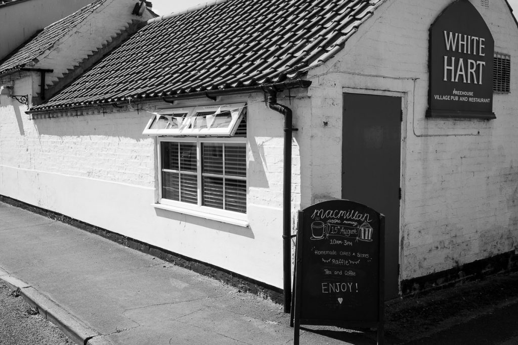 The White Hart Hotel, with a sign about the MacMillan Coffee morning being on 10am to 3pm.  https://www.macmillan.org.uk/coffee-morning