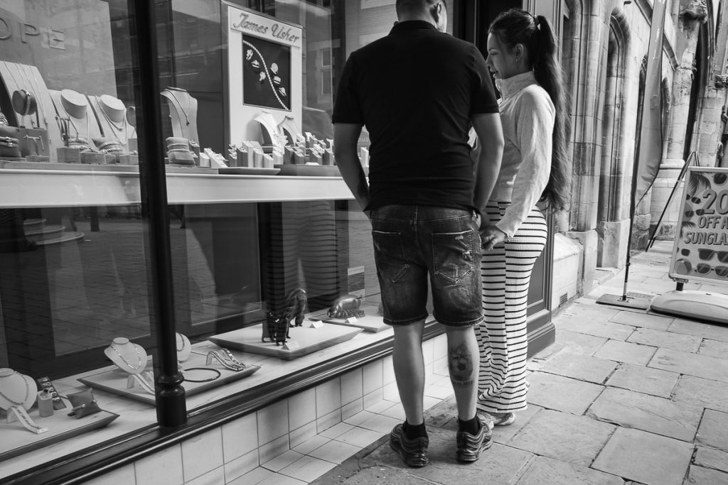 Young couple looking in the window of a local independent jeweller