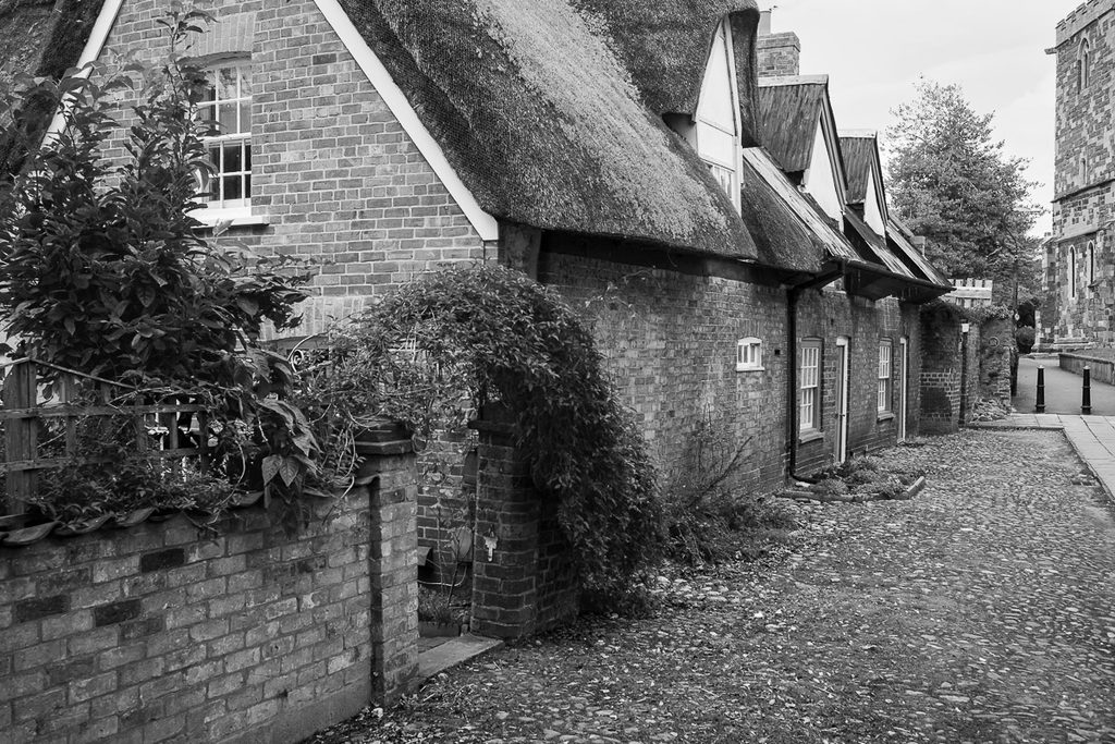 An old thatched town cottage on the way to the old church. Some of the old cobbled street can be seen and past the cottage is the remains of a Roman wall.