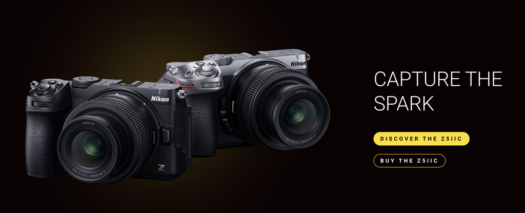 Product shot of a black Nikon Z5IIC to the left and Z5IIC in silver to the right.  Text to the right saying Capture the Spark.